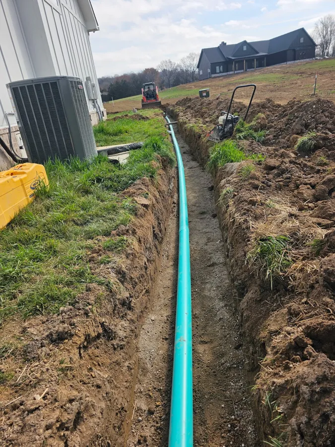 Trench dug and drain line laid beside a house, SC Concrete LLC